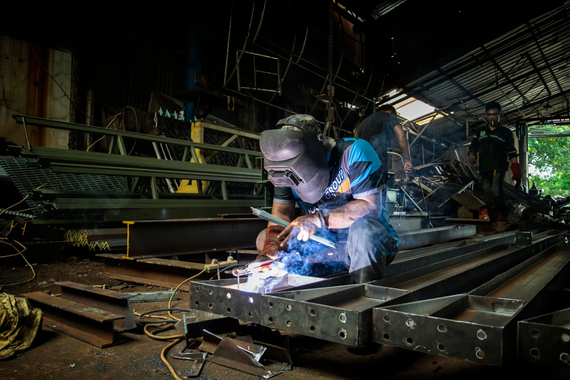 Welding steel beams on a workshop floor
